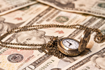 Pocket watch lie on dollars