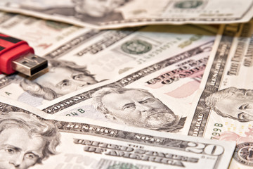 Usb flash drive lies on scattered dollars