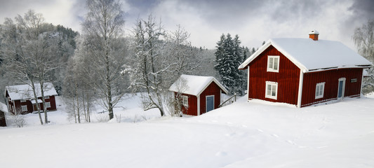 old rural winter scenery with antique red cottages