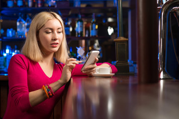 woman with a cup of coffee and cell phone