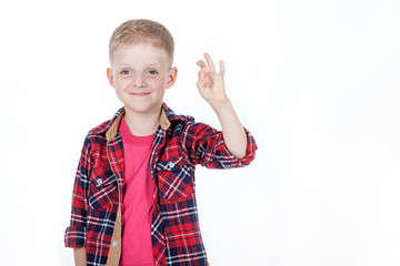 Portrait of happy boy with hands in pockets isolated on white ba