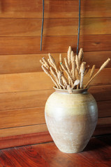Old ceramic vase on wooden floor