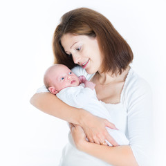 Happy young mother holding her sleeping newborn baby