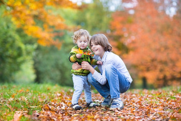 Sweet little toddler girl and her cute brother playing together