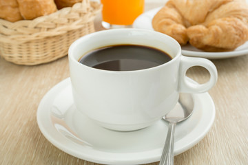 Breakfast with cup of black coffee, breads and juice