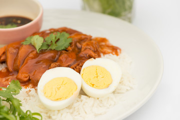 Thai cuisine red pork over rice with boiled egg