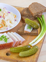 Marinated cabbage (sauerkraut), pickled cucumber,pieces of lard