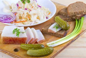 Marinated cabbage (sauerkraut), pickled cucumber,pieces of lard