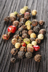 pepper corns on a wooden board