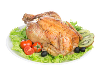 Garnished roasted christmas chicken on a plate decorated with sa