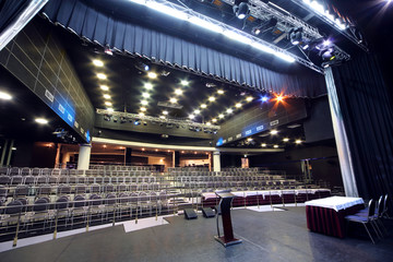 Document stand and table on stage and rows of seats