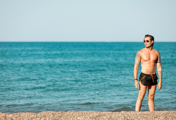 Portrait of men posing at the beach