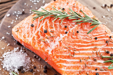 Salmon filet on a wooden carving board.