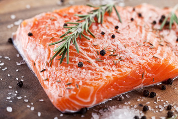 Salmon filet on a wooden carving board.
