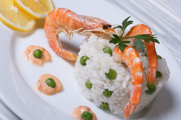 risotto with shrimp and green pot on the table