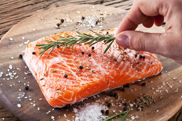 Salmon filet on a wooden carving board.