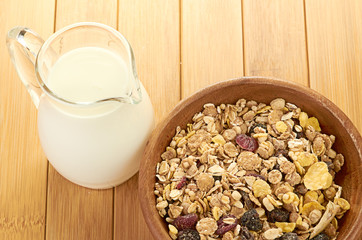 Plate with raw oatmeal on wooden table.