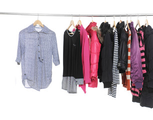 Set of colorful clothes hanging on clothes rack