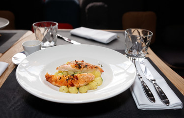 Chicken breast with potatoes on plate