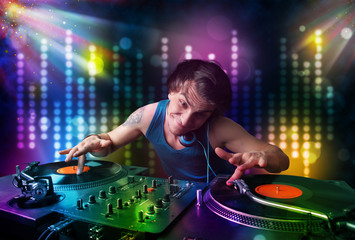 Dj playing songs in a disco with light show
