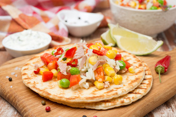 colorful vegetable salad with tuna and cream sauce on tortillas