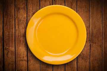Colorful empty plate on grungy background table