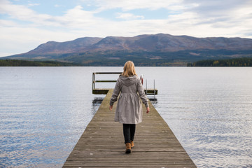 lonely woman walking on a pier