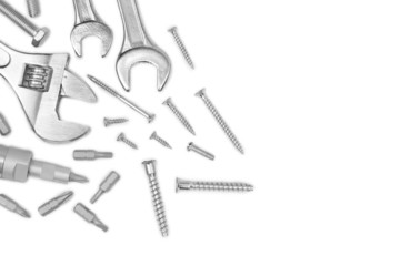 Different tools and screws on white background