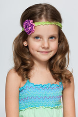 Pretty little girl on the grey background