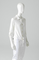Mannequin dressed in white shirt with trousers on gray