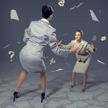 two businesswomen fighting as sumoist