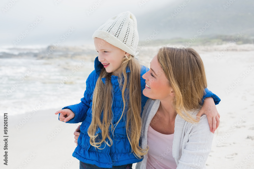 Wall mural girl showing something to mother at beach