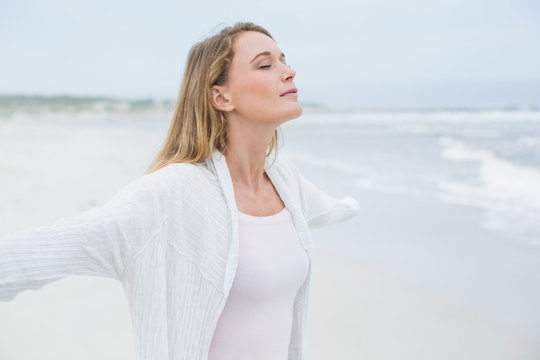 Peaceful casual woman with eyes closed at beach