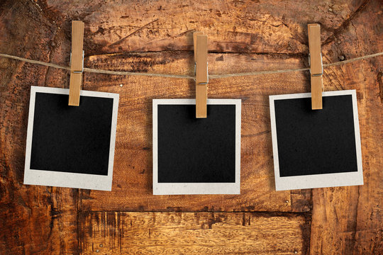 snapshots hanging on a wooden board