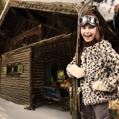 Obraz na płótnie Canvas Ski, winter vacation - girl with retro ski equipment