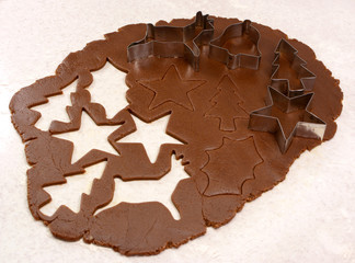 Gingerbread dough cutout shapes and biscuit cutters