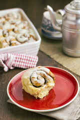 Cinnamon roll with baking dish behind