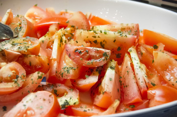 Fresh tomatoes in a white bowl.