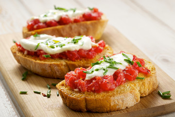Bruschetta with tomato, mozarella and chive