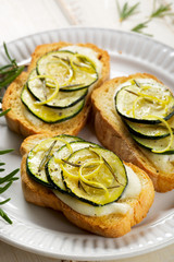 Bruschetta with stewed zucchini, mozzarella and rosemary