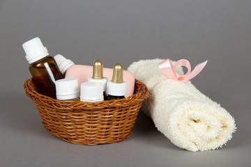 Fototapeta na wymiar Hotel cosmetics kit and terry towel in basket
