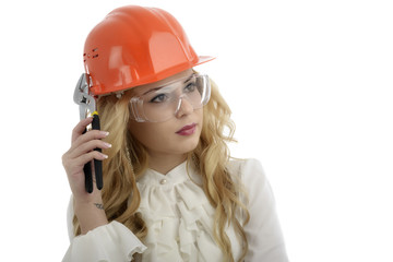 A woman with a helmet with a pipe wrench and safety glasses