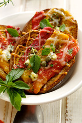 Bruschetta with roasted bell pepper, cheese, capers and oregano