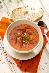 Pepper and tomato soup with fresh herbs and cheese