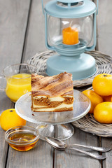 Piece of toffee and vanilla cake on transparent glass cake stand