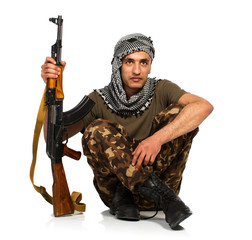 Arab nationality in camouflage suit and keffiyeh with automatic