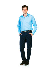 Fototapeta premium Happy young businessman standing with his hands in pockets on wh