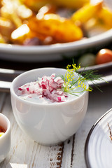 Fresh yogurt dressing with red onion and dill