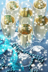 Glasses with champagne on shiny background
