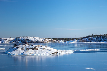 Fototapeta na wymiar Small islands in the sea in winter scenery.